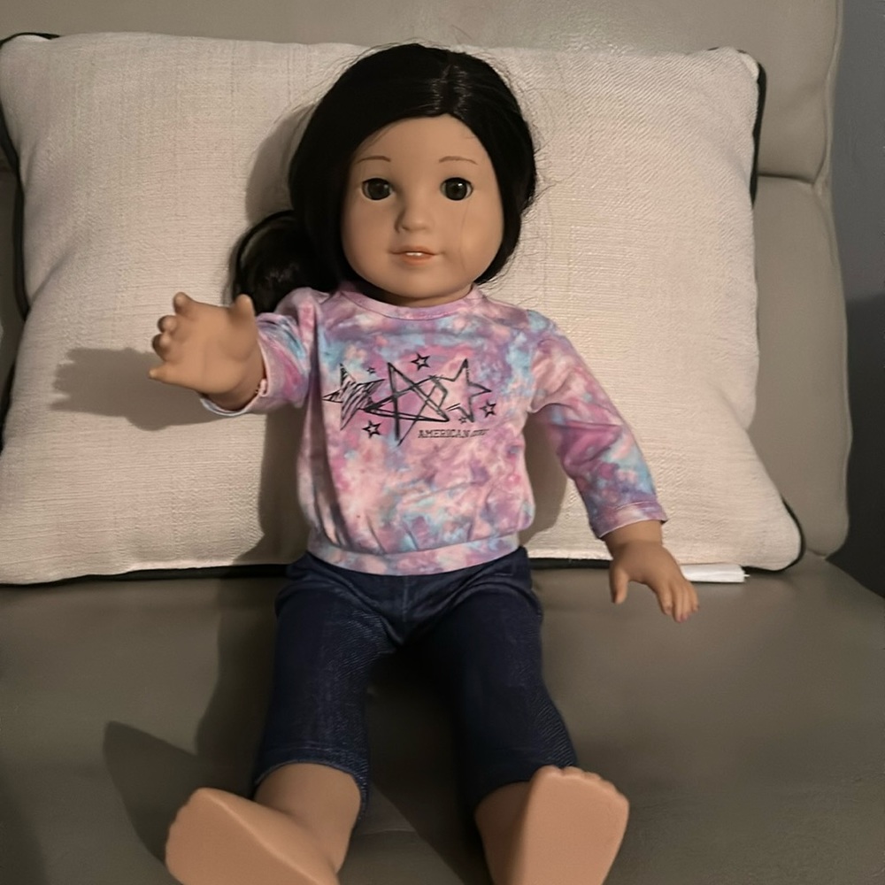 Gently used American Girl Doll with American Girl Doll outfit minus shoes.